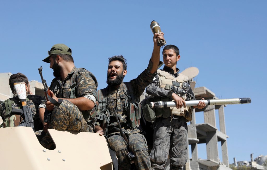 Fighters of Syrian Democratic Forces celebrate after Raqqa in Syria was liberated from Islamic State militants on Oct. 17....