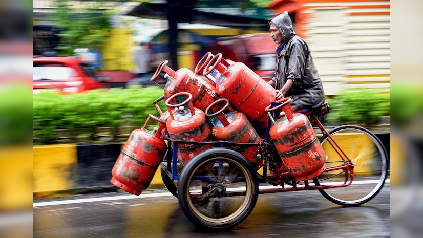 Delivery man transports LPG cylinders on a cart